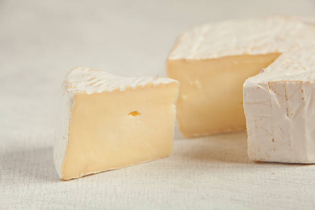istock Fresh brie cheese with white mold on a white background 613667752