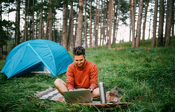 istock Young man camping in the forest 613668850