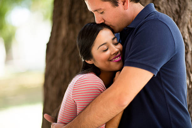 istock Caring young latin couple embracing 613668890