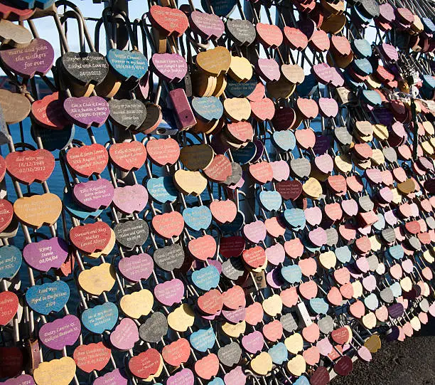 People are now leaving small, personalised padlocks with mottos and names on them at bridges and well know landmarks across the world.