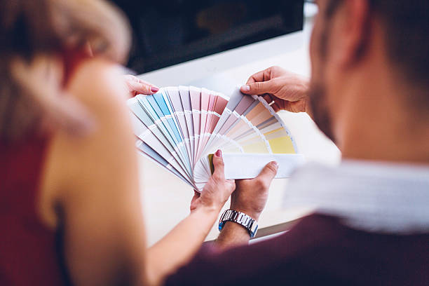 istock Interior designers pointing at color charts 613670112