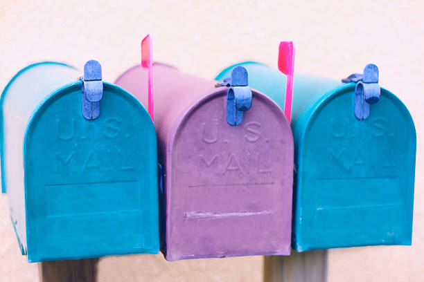 istock Three Purple and Blue Rural Mailboxes with Red Flags Up 613671022