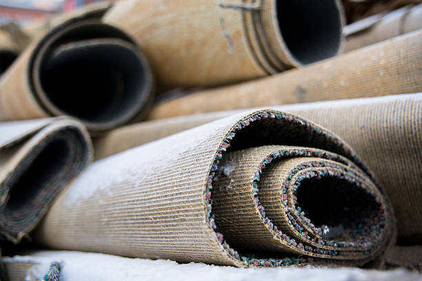Carpet rolls trowed out for garbage stock photo