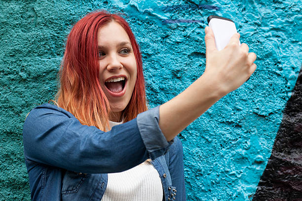 istock Young woman taking a selfie 613673442