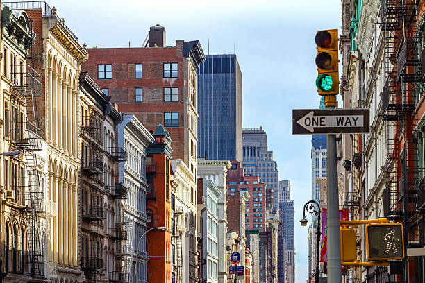 New York City Street Scene in SOHO Intersection of Broadway and Spring Street in SOHO Manhattan, New York City soho new york stock pictures, royalty-free photos & images