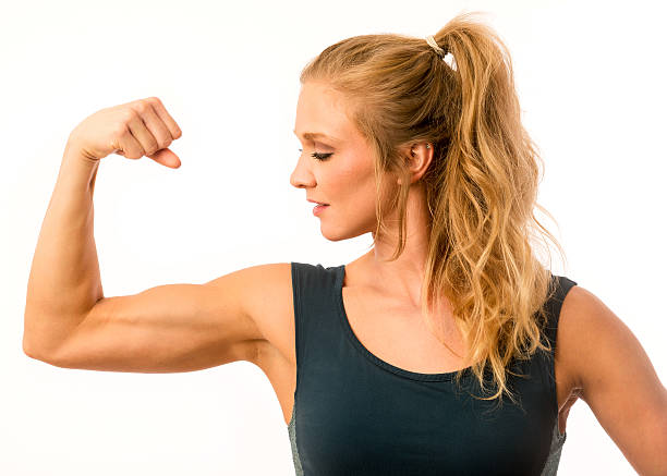istock Fitness Model Flexing Arm Muscles 613674288