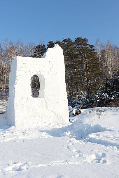istock Snow fortress against the sky and trees 613674642