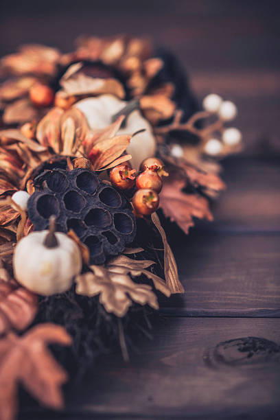 istock Ornate fall wreath with gold pumpkins laying on wood 613674702