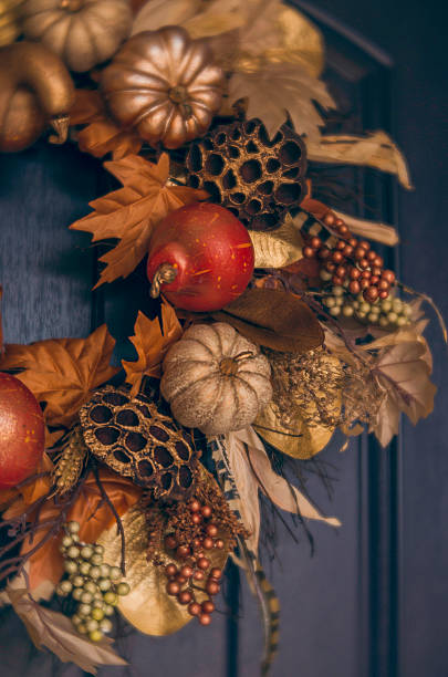 istock Ornate fall wreath with gold pumpkins hanging on front door 613675200