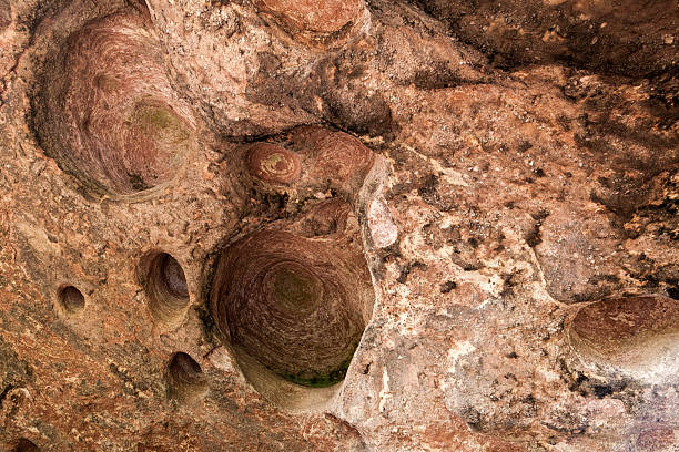 istock Holes eroded into the rock along. 613675394