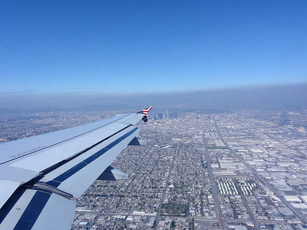 istock Looking out Airplane Wing with View of Downtown LA 613676512