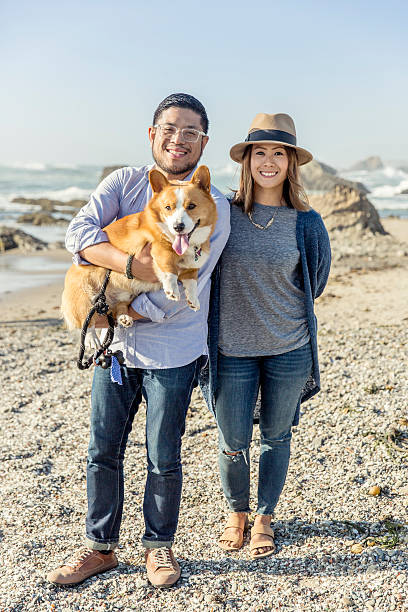 Happy Couple with Corgi at the Beach