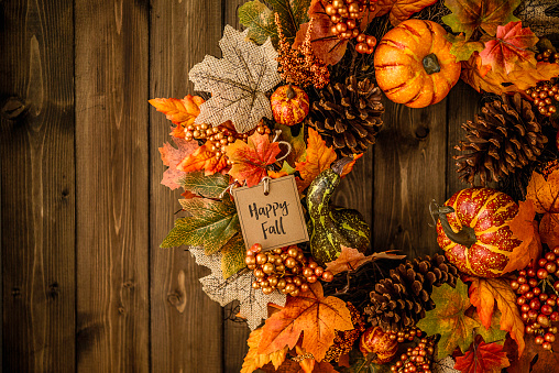 Ornate fall wreath with pumpkins, pinecones, message and leaves