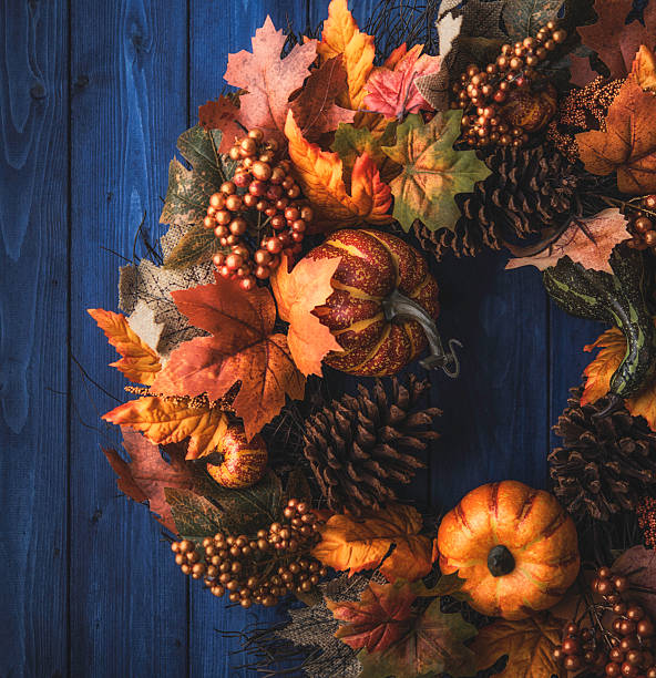 istock Ornate fall wreath with pumpkins, pinecones and leaves 613677842