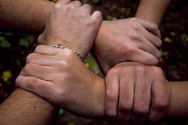 istock two men holding hands symbolizing friendship 613677900