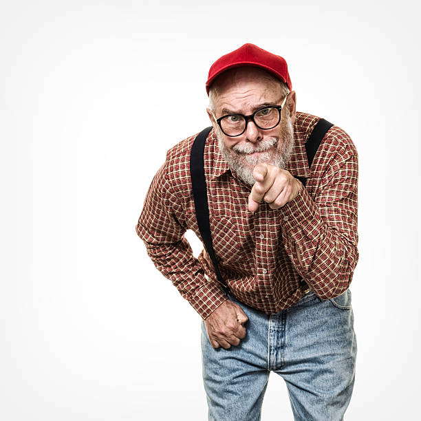 istock Redneck Red Hat Suspenders Hillbilly Senior Man Pointing and Accusing 613679220