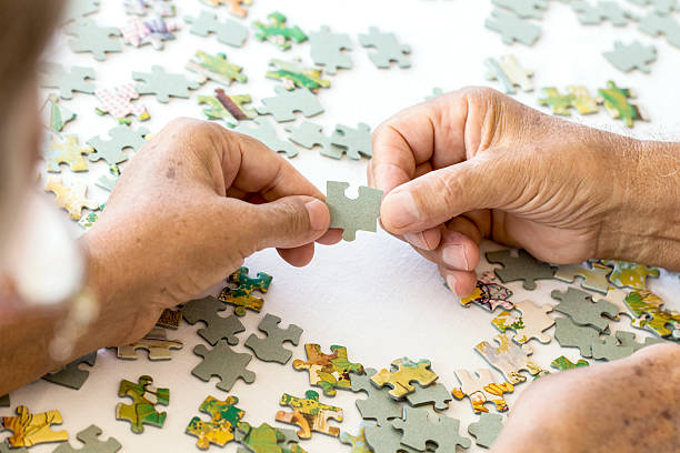 Senior Couple is Playing Puzzle.