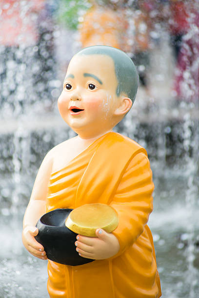 istock Close up Cute Kid Thai Monk Statues of Buddhist 613684502