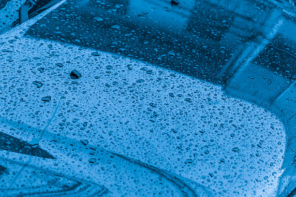 istock Raining water drop with reflect on car hood 613684556