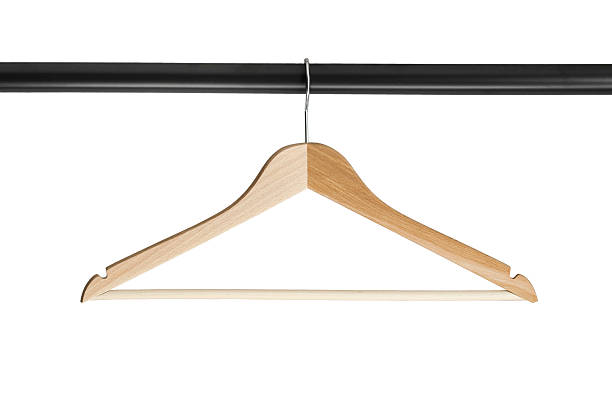 Clothes rack isolated Wooden clothes rack on metal crossbar isolated over white clothes hanger rod stock pictures, royalty-free photos & images