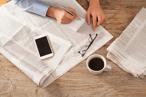 istock Young woman reading newspaper 613685426