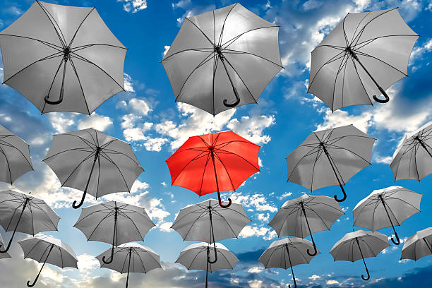 umbrella standing out from the crowd unique concept mental health stock photo