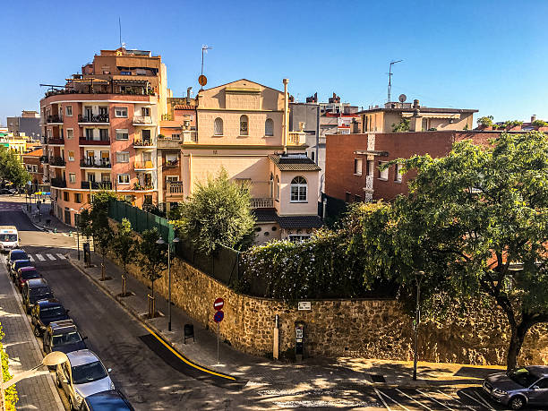 Barcelona, Spain - September 28, 2016: Residential district in Barcelona, Spain. Cars parked on the streets and people walking