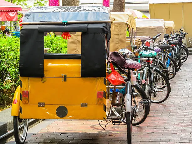 Trishaws expect passengers on the street of Singapore