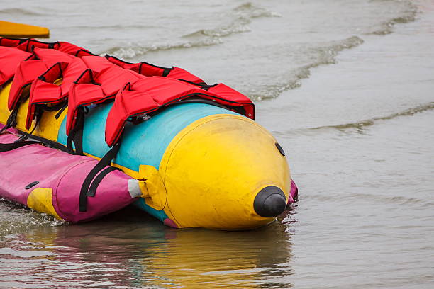 istock Banana boat lays on the beach 613686854
