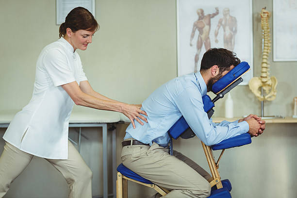 istock Physiotherapist giving back massage to a patient 613688380