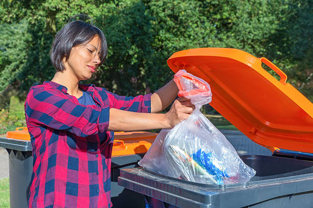 Dutch woman throwing plastic garbage in thrash bin