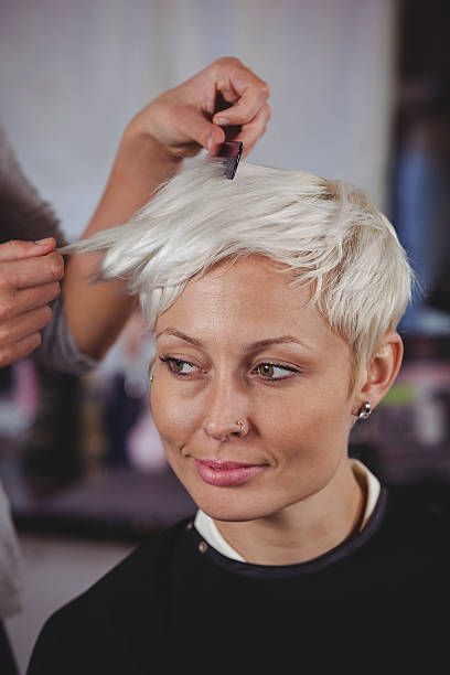istock Female getting her hair trimmed 613688790