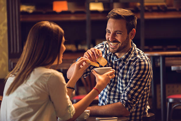 Happy man enjoying in afternoon tea with his girlfriend.