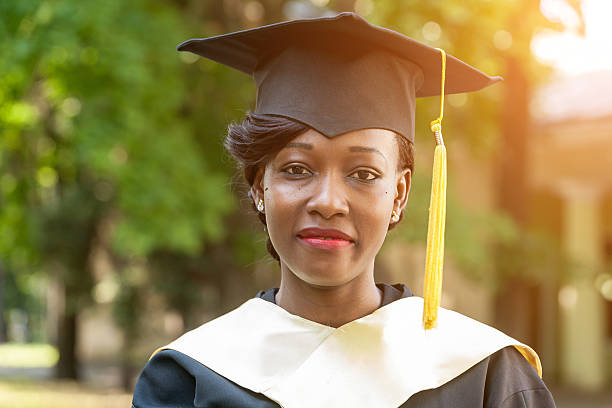 pretty african female college graduate stock photo