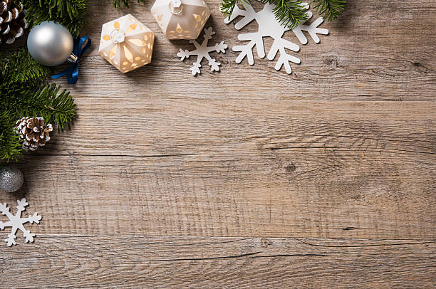 Xmas background Christmas background on wooden table with copyspace. Top view of xmas tree with pine cone and snowflake. Christmas fir branch with silver balls. fake snow stock pictures, royalty-free photos & images