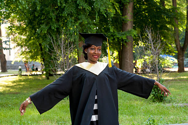 istock Graduate students wearing graduation hat and gown 613689482