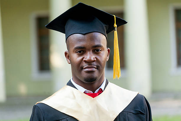 istock Graduate students wearing graduation hat and gown 613689956
