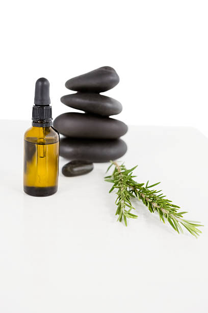 istock Aromatherapy oil with rosemary and pebbles 613690068