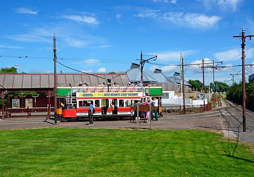 Seaton, United Kingdom - July 18, 2016: View of a Seaton Electric Tramway Tram outside the tram station with people enjoying the setting, Seaton, Devon, England, UK, Western Europe.