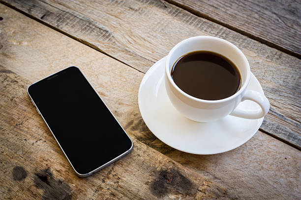 istock cup of coffee on wood table background 613690806
