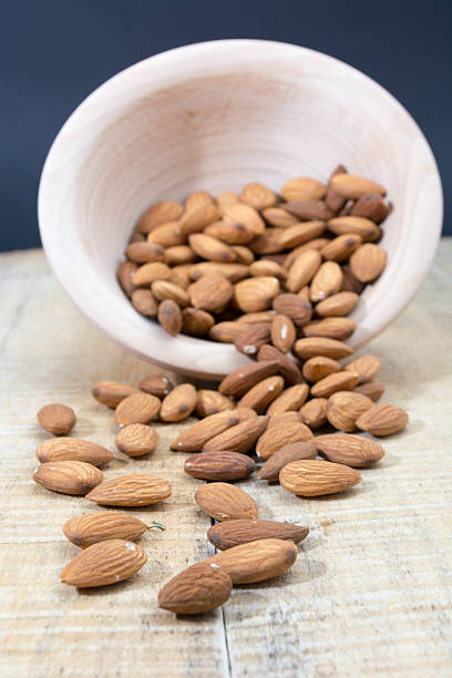 istock Spilled almonds from the bowl 613691140