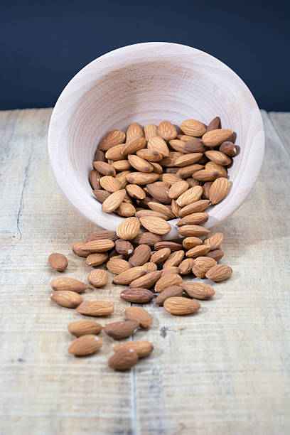 istock Spilled almonds from the bowl 613691614