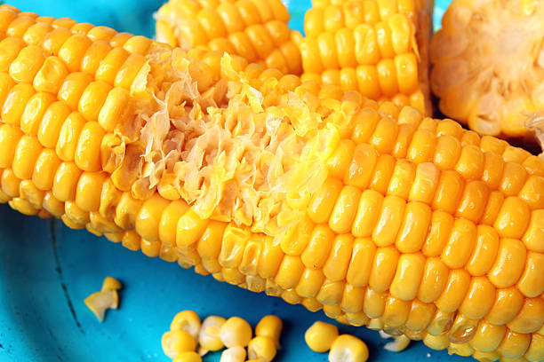 istock Boiled corn and chopped corn ear in blue plate 613692488