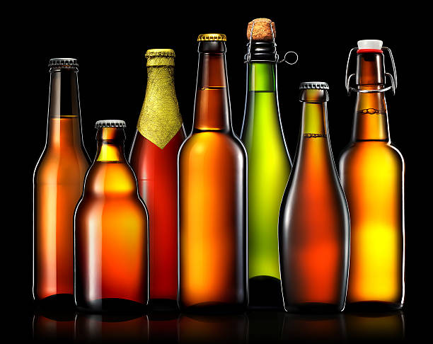 istock Set of beer bottles isolated on black background 613692750