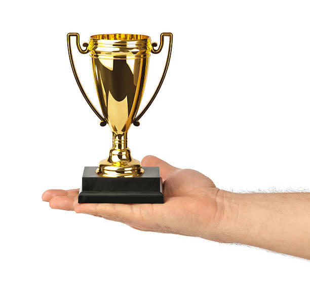 istock Golden trophy cup in hand 613693406