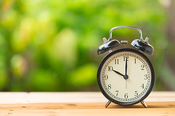 istock clock on green garden time at 10 o'clock 613693580