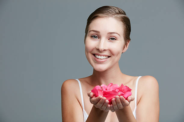 Beautiful woman on the background of a large flower. Beauty summer model girl with pink peony. Young woman with elegant hairstyle and makeup. Fashion photo