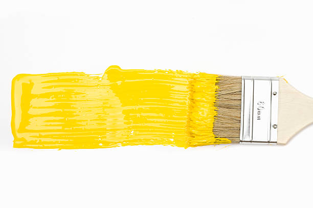 paintbrush with yellow paint - tinta equipamento de arte e artesanato imagens e fotografias de stock