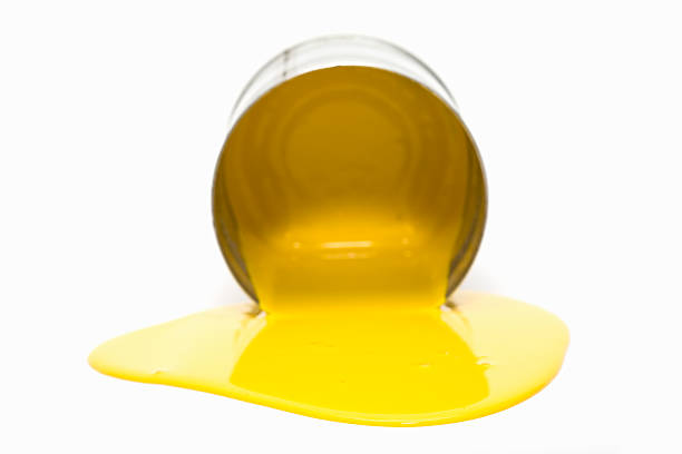 istock Tipped over bucket with yellow paint 613694846