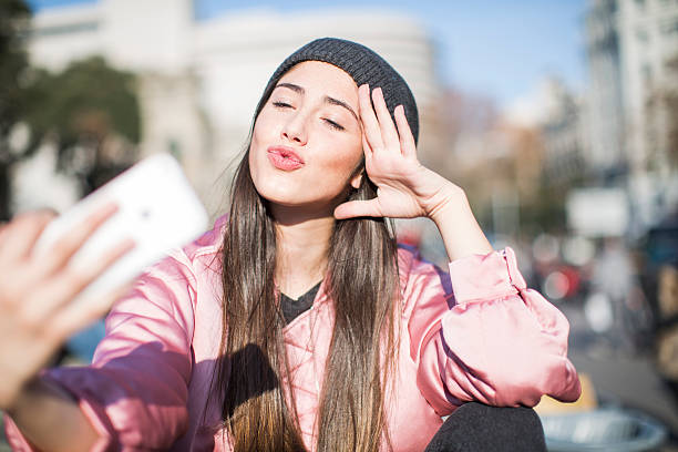 Young woman with smart phone in Barcelona, technology.